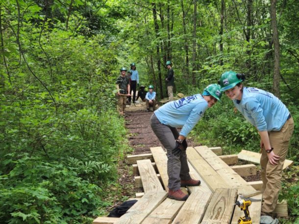 two corps members pose with completed carpentry work